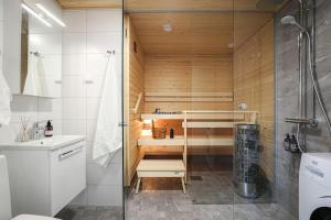 a bathroom with a sauna with a shower at LadyCrane apartment, sauna and parking in Kirkkonummi