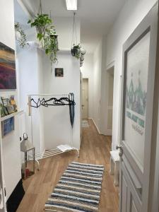 a room with a hallway with a rug and a door at königsnachbar in Ludwigsburg