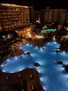a view of a large pool at night at Z-apartment in 5 star hotel in Sunny Beach in Sunny Beach