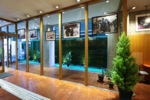 a lobby of a building with plants in the windows at Hotel Landmark Umeda in Osaka