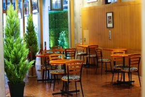 a row of wooden tables and chairs in a restaurant at Hotel Landmark Umeda in Osaka