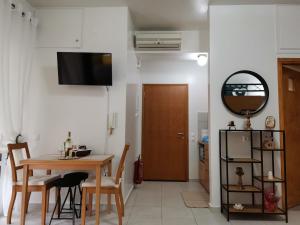 a kitchen and dining room with a table and a mirror at Floras House in Karistos
