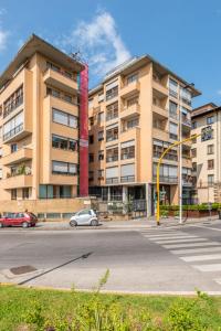 a large apartment building with a car parked in front of it at Lungarno del Tempio River View by 360Rentals in Florence