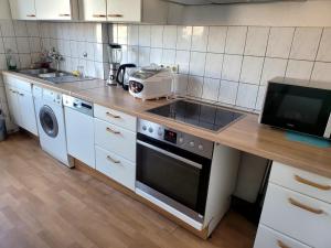 a kitchen with a counter with a stove and a microwave at Perfect Resting Rooms in Bremen