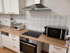 a kitchen with a counter top with a microwave at Perfect Resting Rooms in Bremen