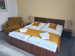 ein Schlafzimmer mit einem großen Bett und einem Sofa in der Unterkunft Hotel Eminent in Stupava