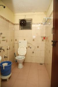 a bathroom with a toilet and a shower at DASWAL GARDEN HOME in Madikeri