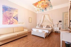 a bedroom with a bed and a couch at Hotel Ristorante Ala d'Oro in Lugo