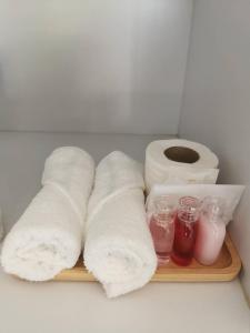 a wooden tray with rolls of toilet paper and some sauce at NST Boutique เอ็นเอสทีบูทีค in Ban Pak Phun