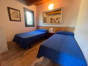 a room with two beds and a mirror in it at Villa Sergi in Les tres Cales
