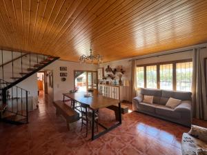 a living room with a table and a couch at Villa Sergi in Les tres Cales