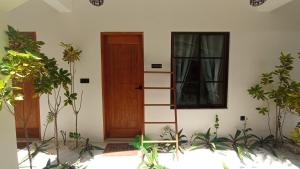 a room with a ladder next to a door at Ahiva Village in Fulhadhoo