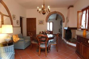 a living room with a table and chairs and a couch at Comiti Farmhouse Apt Bondone in Montaione