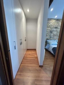 a hallway leading to a bedroom with a bed at Kareharri Piso en Casco Viejo de Zarautz in Zarautz