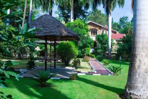 a garden with a gazebo and a house at Mama Thea homes in Moshi