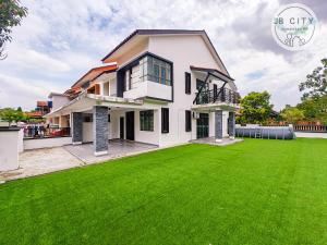 a house with a large lawn in front of it at Two-Nine Muslim Villa by RR JBcity in Johor Bahru