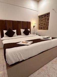 a large bed in a hotel room with a large bedvisor at Candolim beach touch flats in Candolim
