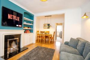 a living room with a couch and a fireplace at House in Malton in Norton