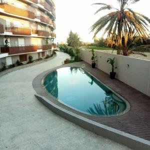 a swimming pool in the middle of a building at Cosy in a water front residence in Sousse