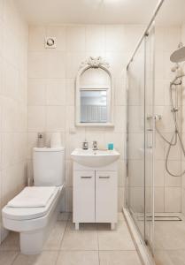 a bathroom with a toilet and a sink and a shower at Nowy Świat 30 Luxury Apartment in Warsaw
