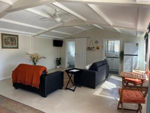 a living room with two couches and a ceiling at Shazza’s Desert Oasis in Broken Hill