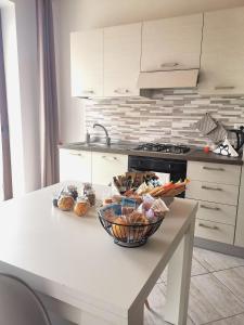 a kitchen with a table with a bowl of food on it at Paradeisos Residence Sas in Somma Lombardo