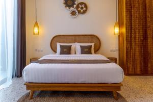 a bedroom with a large bed and a clock on the wall at Sunny Village Batu Bolong in Canggu