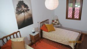 a small bedroom with two beds and a window at Casa Rural, paz y naturaleza. 