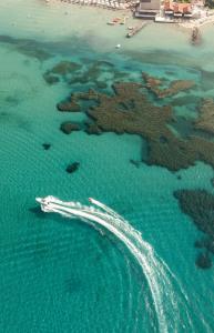 an aerial view of a boat in the ocean at Robolla Beach Aparthotel in Roda