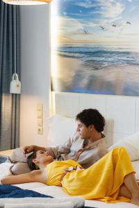 a group of people laying on a bed at Robolla Beach Aparthotel in Roda