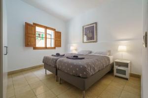a bedroom with a bed and a window at Maca Green, Adosado Centro Campanet in Campanet