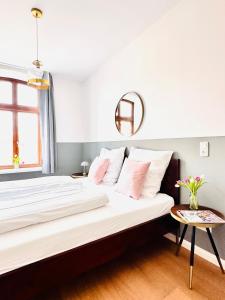 a bedroom with a large bed with a table at Wellenreiter in Tating +33 photos