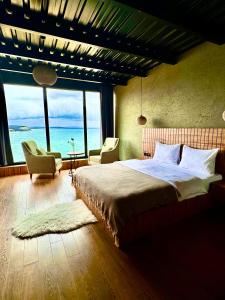 a bedroom with a bed with a view of the ocean at Marina Fener Hotel & Suite in Istanbul