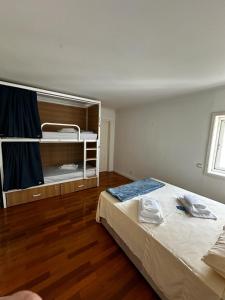 a bedroom with a large bed and a bunk bed at VHostel in Guimarães