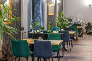 a row of tables and chairs with plants at DW Atrium in Polańczyk