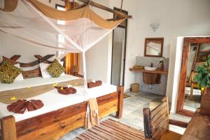 a bedroom with two beds and a fireplace at Z-Lodge Zanzibar in Kiwengwa