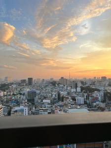 a view of a city at sunset at Otis Soho Saigon Balcony Apartment in Ho Chi Minh City