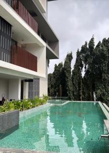 a swimming pool in front of a building at Rosewood luxury 1 bedroom @ Solaris in Accra