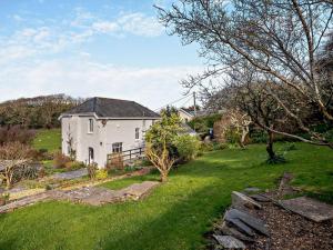 a white house in a yard with a green lawn at 4 Bed in Fairbourne 42772 in Fairbourne