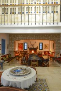 a living room with a table and a fireplace at Dar Chennoufi in Sicca Veneria