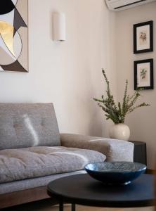 a living room with a couch and a table at Touching Acropolis - Quiet & Elegant 1-Bdr Apt in Athens