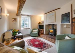 a living room with a couch and a fireplace at Chapel Cottage in Hempstead