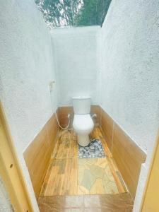 a bathroom with a toilet in the corner of a room at Ima Villa Sigiriya in Sigiriya