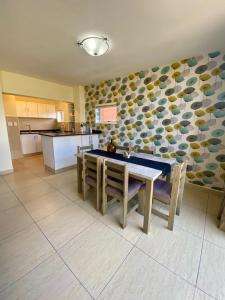 een keuken met een tafel en stoelen in een kamer bij The Oceanic 2 Bedroom with Ocean View - Self Catering Apartment in Durban