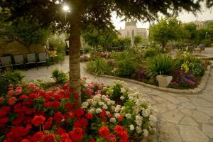 a garden with colorful flowers in a park at St. George’s Cathedral Pilgrim Guesthouse – Jerusalem in Jerusalem