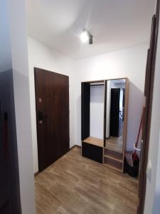a room with a mirror and a door at Sunny Apartament in Darłowo