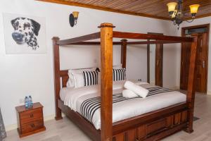 a bedroom with a wooden bunk bed in a room at Elevate by African Manor in Bungoma