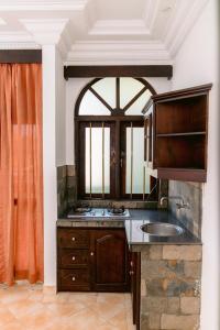 a kitchen with a sink and a window at Romantic garden hotel in Negombo