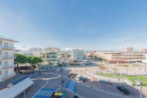 a city with a street with cars and buildings at Residence Playa Grande Immobiliare Pacella in Lido di Jesolo