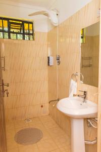 a bathroom with a sink and a shower at Elevate by African Manor in Bungoma